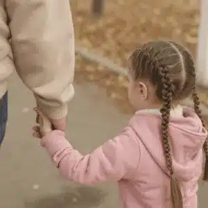 A child walks with parent after asking how do I file for custody of my child?