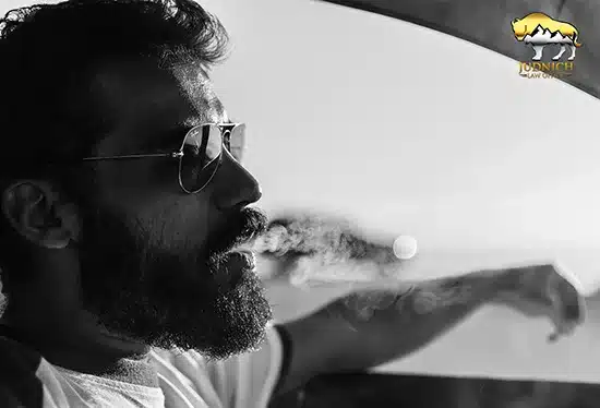 man driving while smoking marijuana