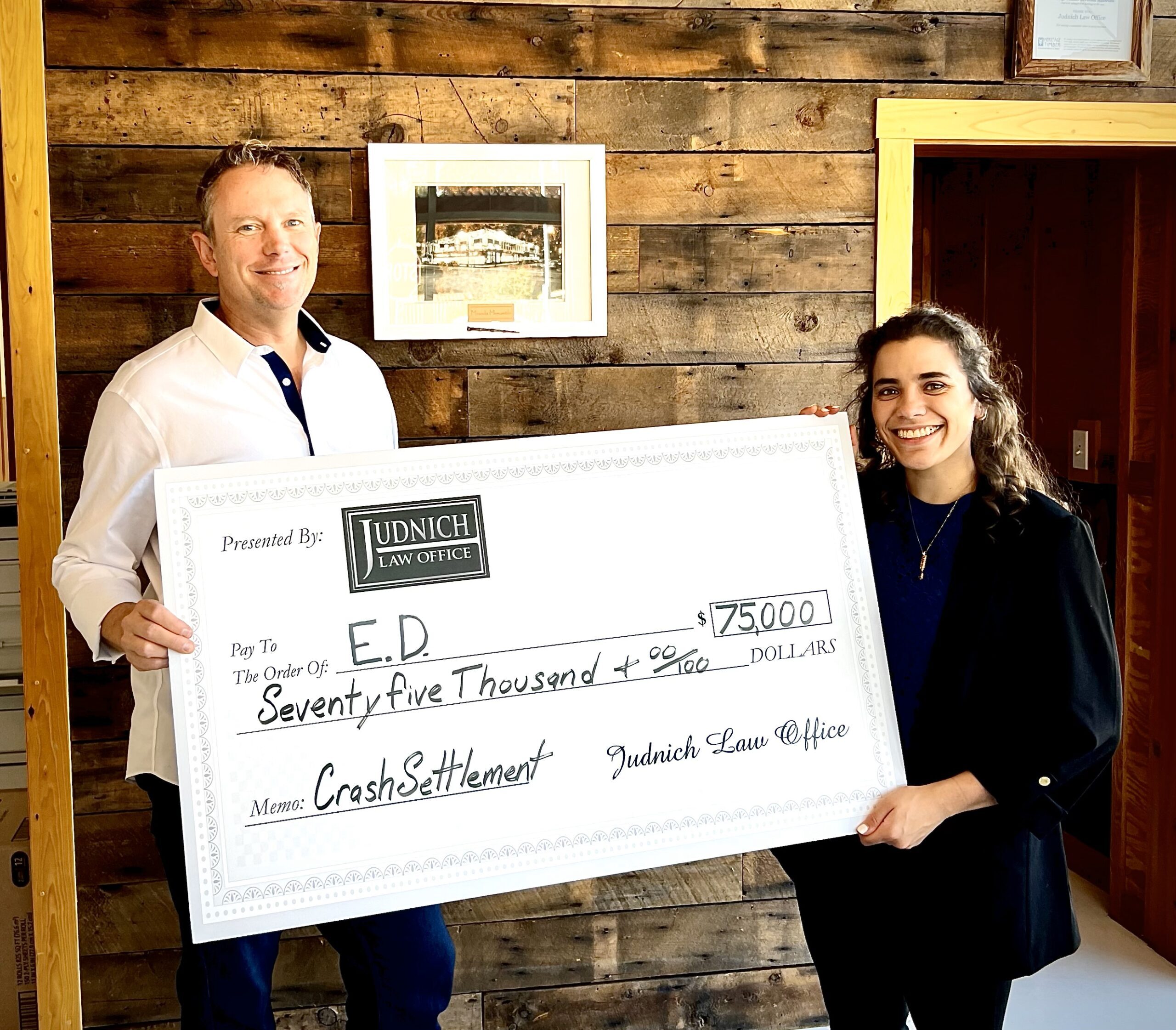 client and attorney holding settlement check